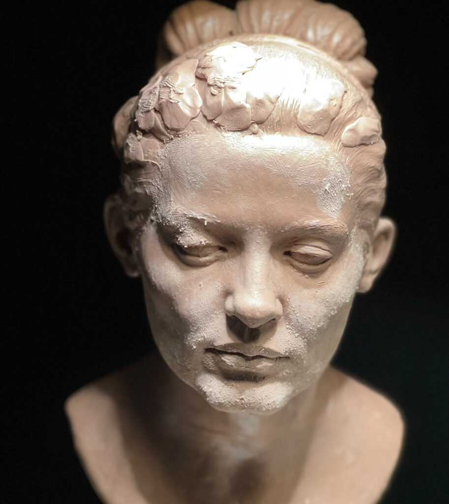 A photo of a sculpture of a female face