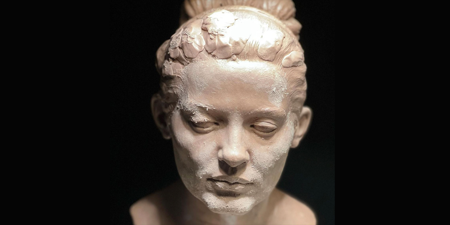 A photo of a sculpture of a female face